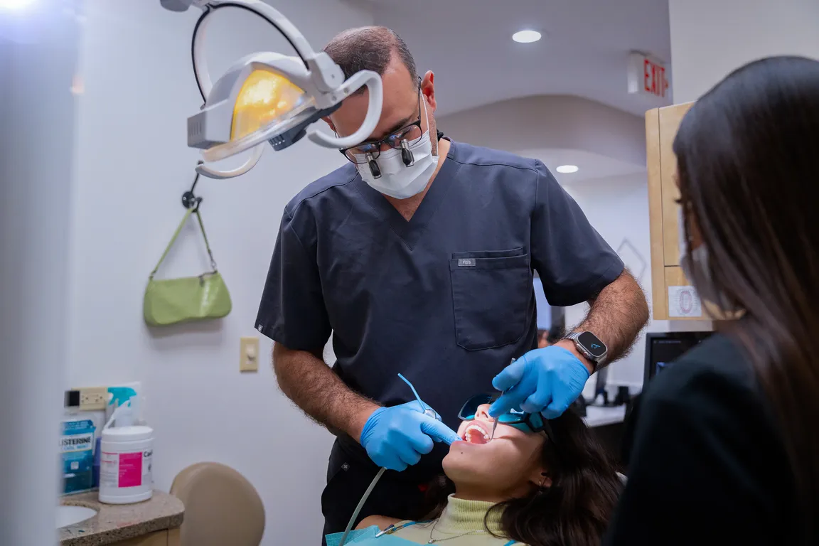 A dentist at work in a treatment room at the Mount Prospect, IL office
