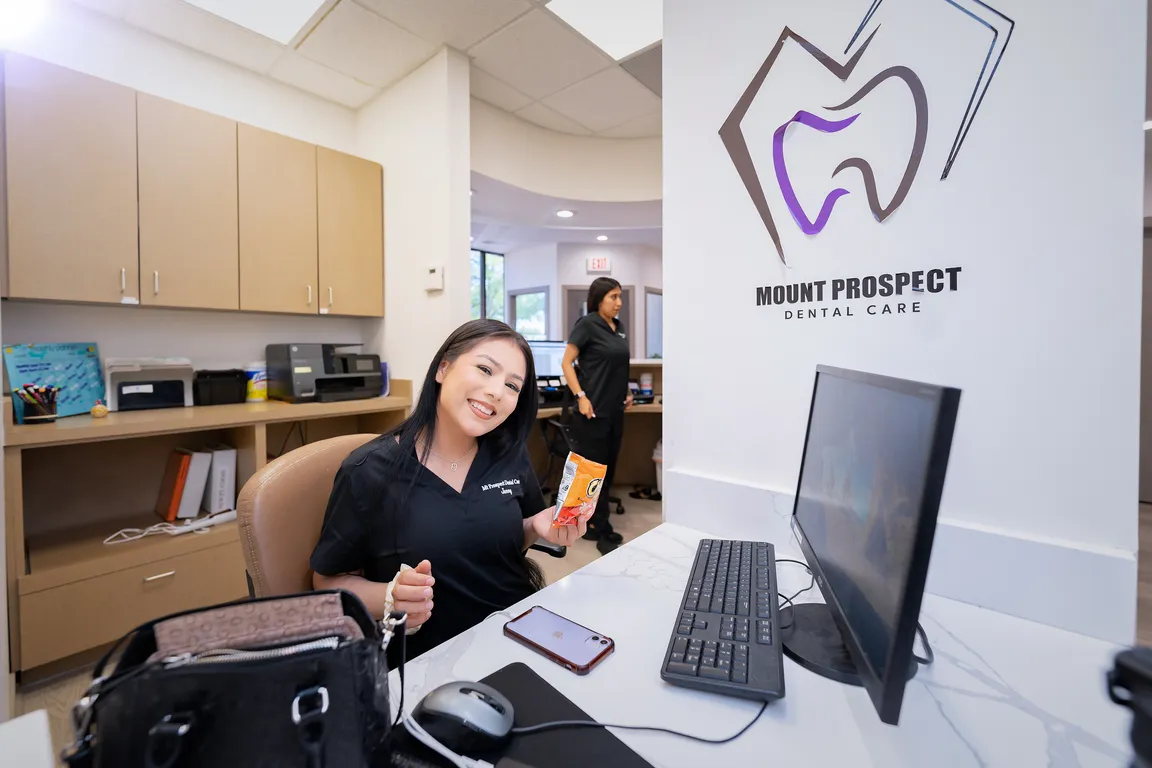 Patient care coordinator at the reception desk of Mount Prospect Dental Care