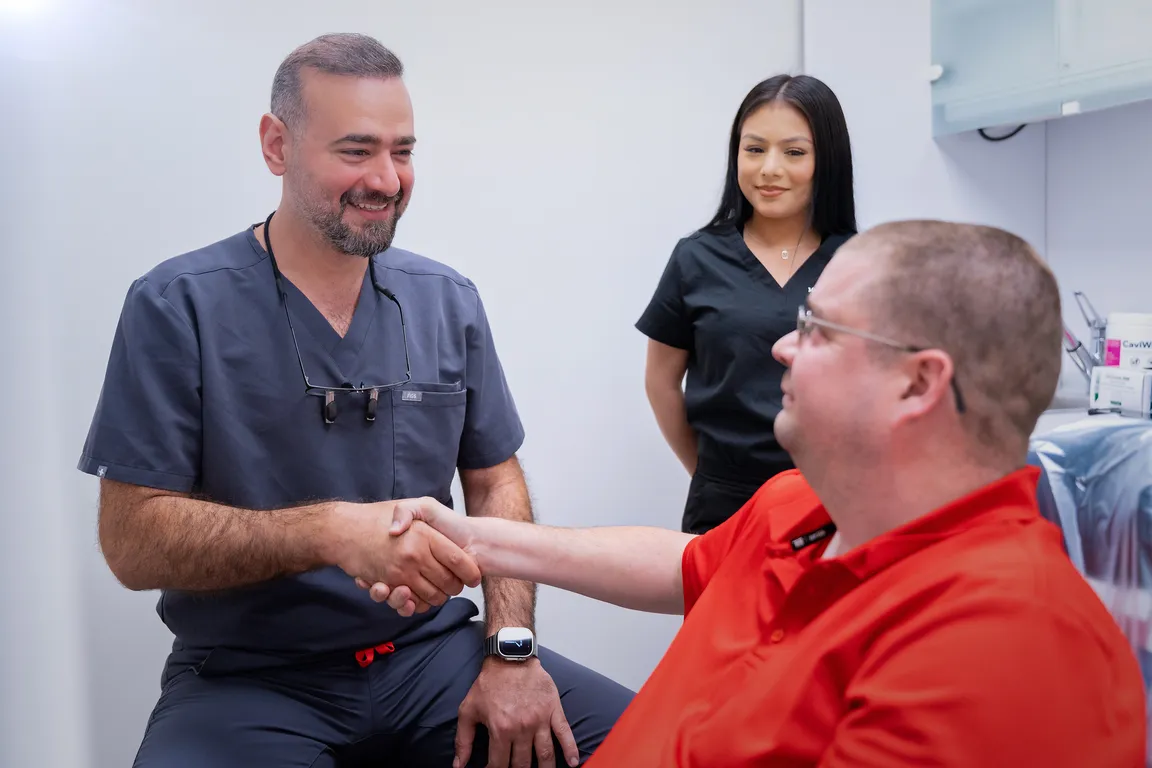 A dentist greeting a patient at Mount Prospect Dental Care