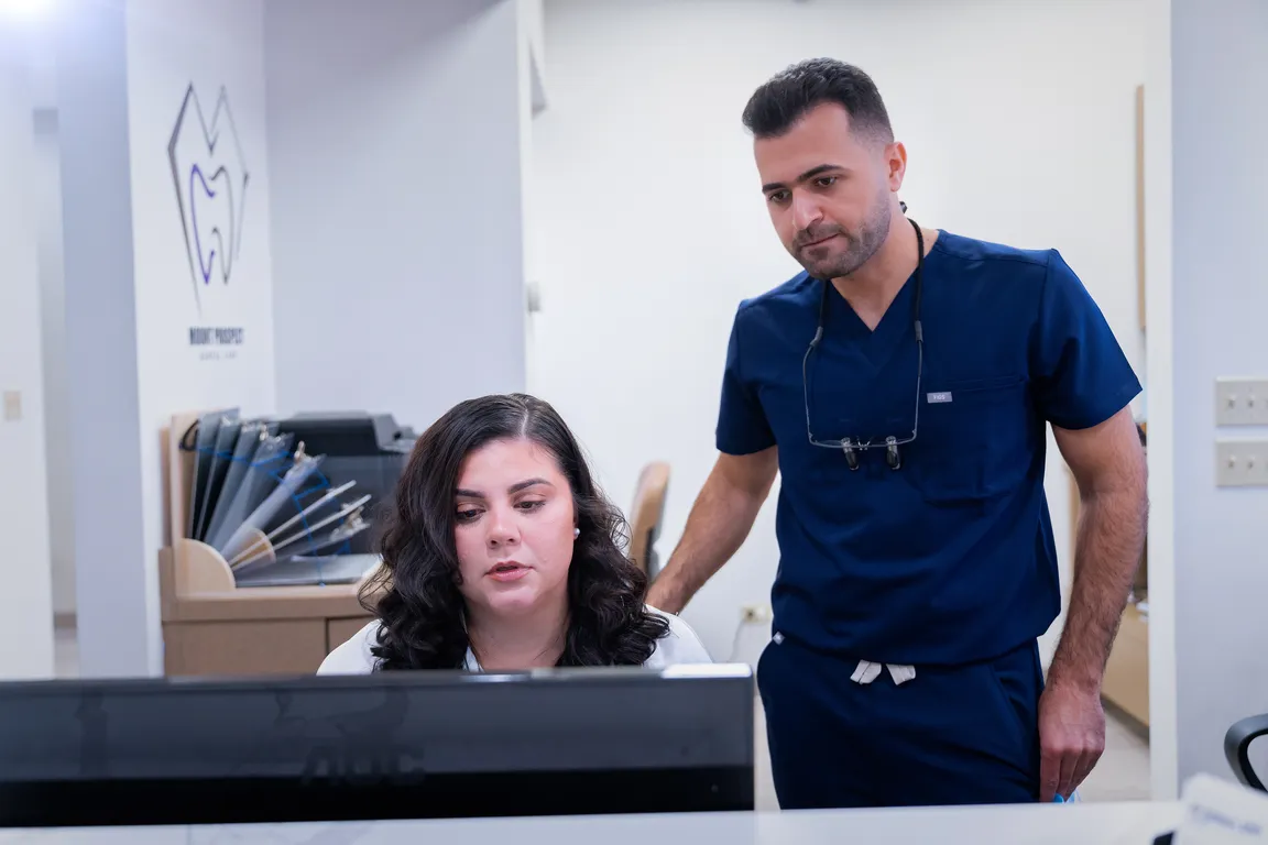 A dentist and team member during a patient consultation in Mount Prospect, IL